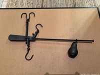Entire steelyard scale laid flat showing arm, hooks, weight