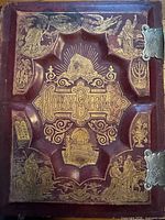 Front cover showing embossed gilt artwork and title