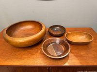 All four wooden bowls displayed together on table