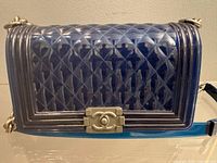 Front view of blue quilted PVC handbag showing CC turn-lock and quilting