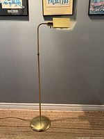 Full view of brass floor lamp standing upright