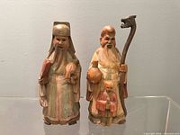 Both wooden Star God figurines front view