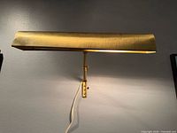 Front view of brass picture light illuminated