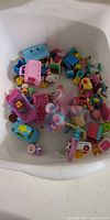 Tub containing assorted Shopkins figures, doll, car, accessories