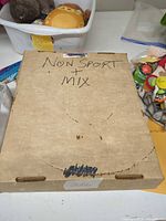 Closed cardboard storage box marked Non Sport + Mix