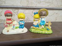 Front view of both Joan Walsh Anglund 1972 ceramic figurines