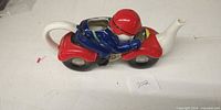 Left side view of ceramic motorcycle rider teapot
