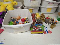 Overall lot view with bin and loose toys on table