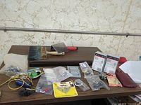 Overview of all tools, electrical parts and paint brush on table