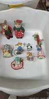 Overall view of all nine miniature holiday mouse figurines and ornaments in bin
