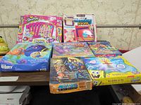 Stack of boxed puzzles, games and craft kit