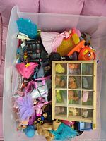 Top view of bin showing bulk of assorted toys and wooden display with teddy bear figurines