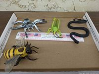 Overview of all four toy animals with ruler for scale