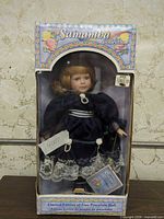 Front view of boxed Samantha Collection porcelain doll