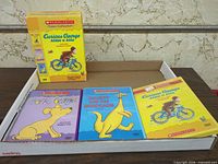 Outer slipcase and three DVD cases visible in tray