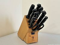 Knives inserted in branded wood block