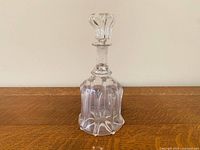 Full view of bell-shaped decanter with stopper inserted