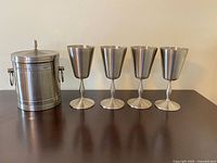Group shot of four goblets and ice bucket with lid closed