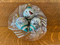 Top view of crystal dish holding three porcelain ornaments