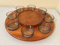 top view showing teak tray with eight glass bowls in recessed wells