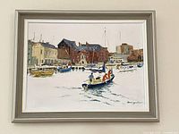 Front view of framed harbour painting hung on wall