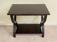 Front view of solid wood console table showing top, curved legs and shelf