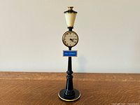 Full view of LeCoultre street-lamp style desk clock on base