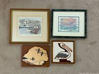 All four framed artworks laid out together