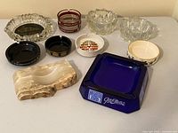 Group shot of all 11 ashtrays showing variety of materials and designs