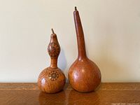 Both gourds standing on surface showing overall forms