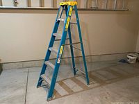 Full view of Reynolds 6 ft fiberglass step ladder opened in garage