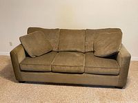 Front view of Stylus three-seat sofa showing cushions and fabric