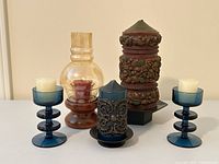 All five items displayed together: two blue Festivo holders, wood hurricane lamp, Hallmark harvest candle, ornate navy candle