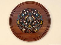 Front view showing entire frog motif design on cedar plaque
