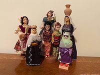 Group shot of all seven folk dolls standing together