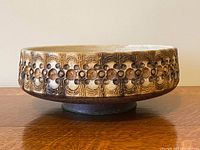 Side view of textured stoneware bowl on pedestal foot