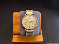 Front view of Bulova Accutron quartz watch on stand showing full dial and band