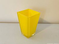 Front angled view showing yellow cased glass vase with clear base