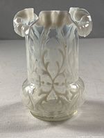 Full view of vase front showing opalescent glass, pattern and ruffled rim