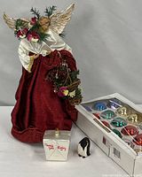 All items together: angel, box of ball ornaments, take-out box ornament, penguin ornament