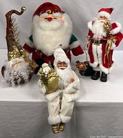 Group shot of four Santa figurines