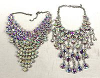 Both iridescent glass bib necklaces laid flat