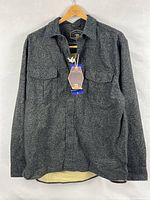 Front view of the flannel shirt jacket showing overall design and tags attached