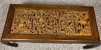 Top view of carved wood coffee table showing detailed relief work