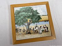 Front view showing framed tile with picnic scene