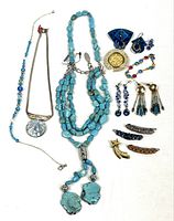 Overview of entire lot laid out: three necklaces, brooch, earrings, bracelet, four barrettes