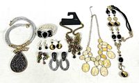 All items laid out showing four necklaces, five pairs earrings, one bracelet