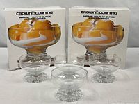 Two original boxes and four of the dessert bowls displayed in front