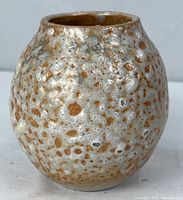 Full view of rust and cream mottled glaze pottery vase