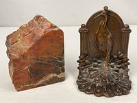 Front view of both bookends: cast iron peacock and polished stone